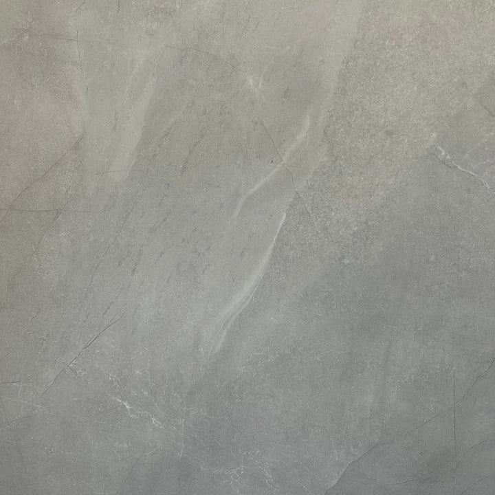Close up of a natural marble satin finish bathroom wall panel with subtle grey and beige veining. The smooth, low sheen surface highlights the premium look of high quality shower cladding. Ideal for modern bathrooms, these shower panels offer a stylish and practical alternative to tiles, with a waterproof, mould resistant finish that is easy to clean and maintain.