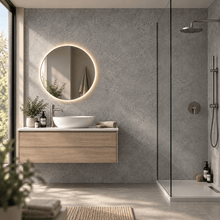 Modern floating bathroom vanity with a white vessel sink, round backlit mirror, and light wood cabinet, set against a textured gray wall beside a glass shower enclosure.